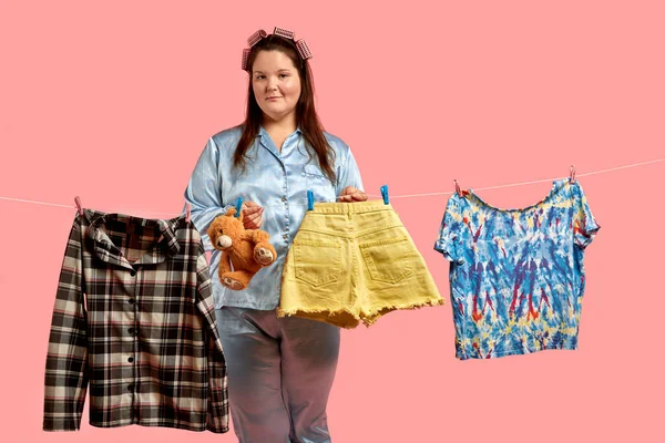 Young woman hangs laundry. Concept of sustainability and purity, deep clean after washing.