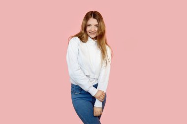 Günlük kıyafetli bir kız kameraya bakar. Eller birbirine bağlanmış..