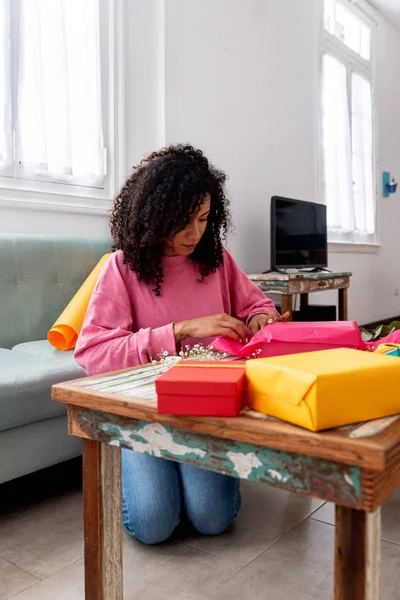 Latin woman wrapping handmade craft gifts on the table at home — 스톡 사진