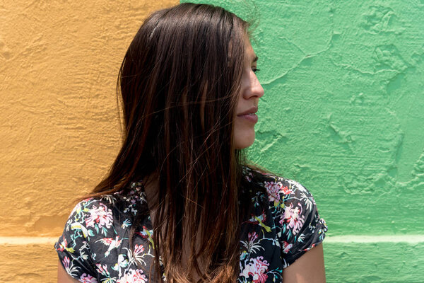 Woman in a dress in front of a bicolor wall in Cholula, Mexico