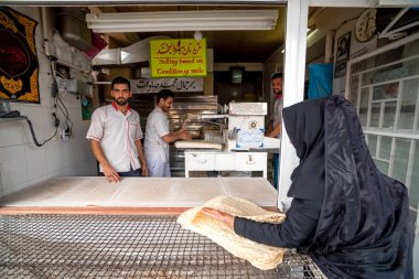 1 Mart 2019: Fırıncı adam geleneksel fırında ekmek üretiyor. Kashan, İran