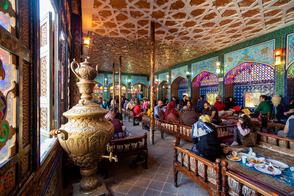 March 2, 2019: Iranians having lunch in a traditional restaurant. Isfahan, Iran