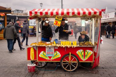 19 Şubat 2018: İstanbul Limanı 'ndaki tezgahına bakan bir mısır satıcısı. İstanbul, Türkiye
