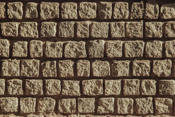 Πέτρινος τοίχος τούβλο υφή μπεζ φόντο επιφάνειας πρόσοψη — Φωτογραφία Αρχείου