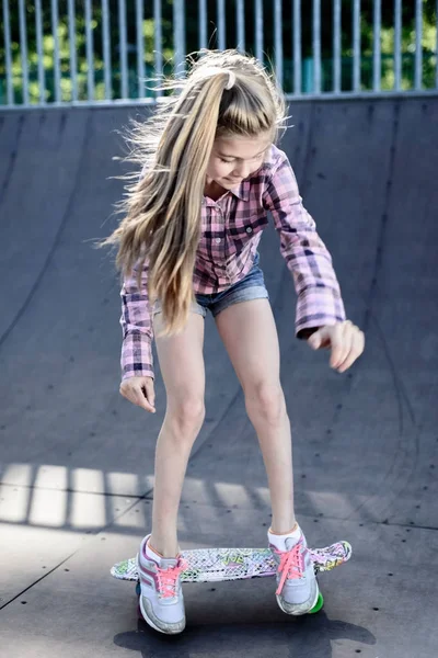 Menina aprende a patinar no skate — Fotografia de Stock