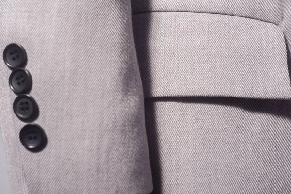 Closeup of a sleeve with buttons of a gray female jacket, business girl — 스톡 사진