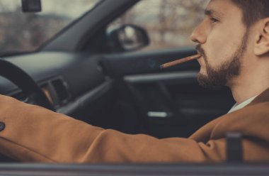 Otuz yaşında genç bir adamın portresi. Yakından bakınca, araba sürerken sigara içiyor. İş elbisesi giymiş sakallı bir iş adamı. Vahşice sigara içiyor. Yaratıcı işlemlerde