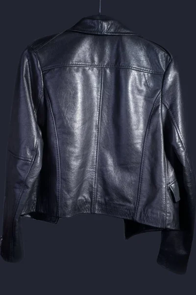 Рекламная фотография для каталога высококачественной кожаной куртки в стиле рок-н-ролла. На темно-сером фоне — стоковое фото