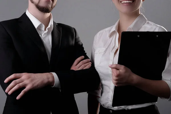 Πορτρέτο των νέων, επιχειρηματίες χαμογελαστοί, στέκονται με κοστούμια επιχειρήσεων, κρατώντας φακέλους γραφείων για χαρτιά στα χέρια τους. Φωτογραφία στούντιο σε γκρι φόντο — Φωτογραφία Αρχείου