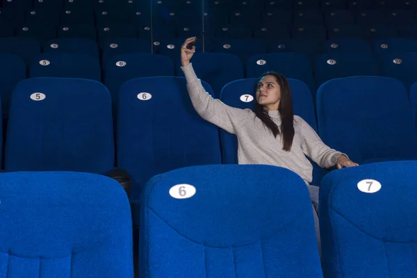 외롭고 소녀가 안락의자에 극장에서 셀카를 혼자서 영화를 극장에서 영화를 있어요 — 스톡 사진