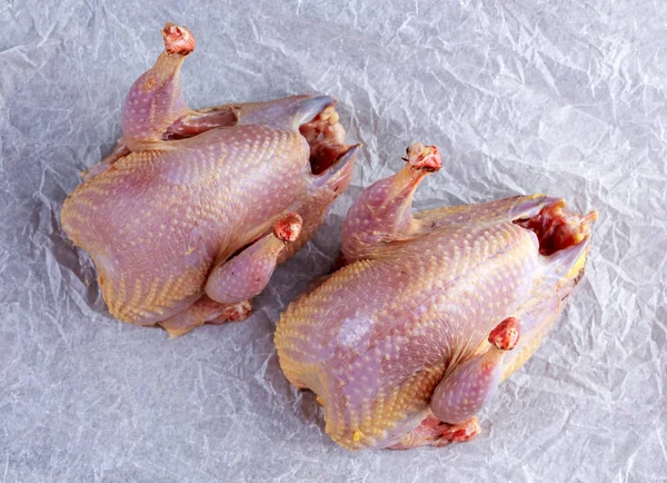 Ready to cook raw seasoned partridges on crumpled paper. — Stock Photo, Image