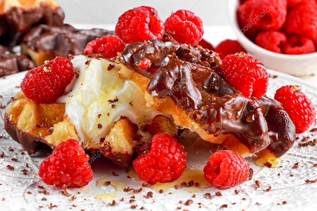 Belgian chocolate waffles with fresh raspberries, whipped cream and honey syrup
