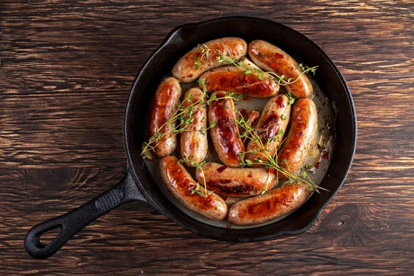 Home-made Pork Sausages in rustic pan with thyme — Stock Photo, Image