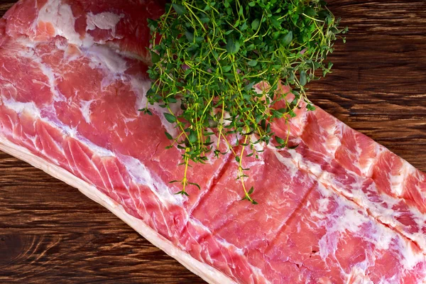 Raw whole back bacon loin with herb on wooden board — Stock Photo, Image