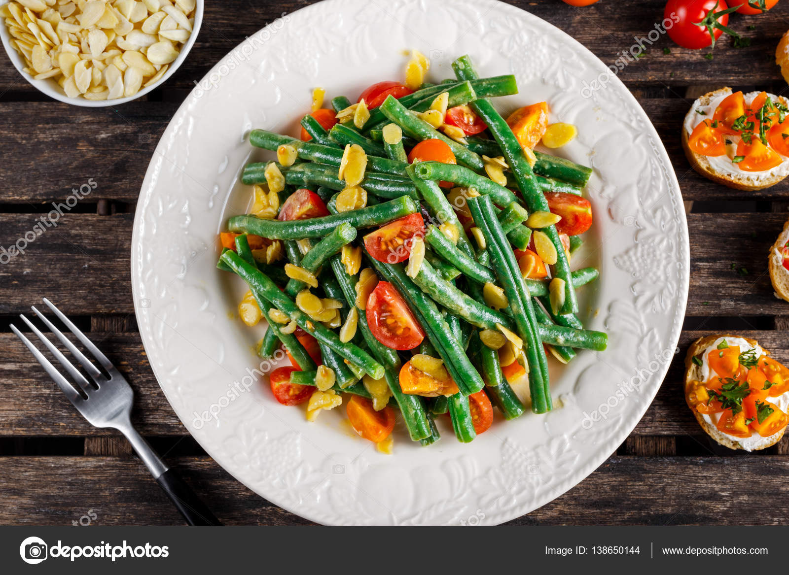 Green beans salad with Red, Yellow Tomatoes, bruschettas and flaked