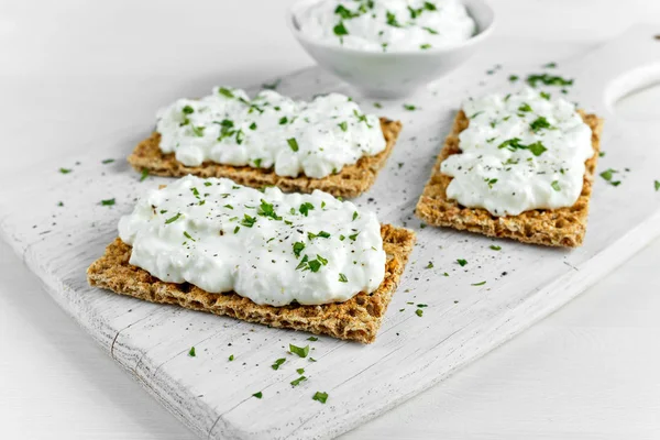 코 티 지 치즈와 파 슬 리 화이트 나무 보드에 만든 Crispbread 토스트. — 스톡 사진