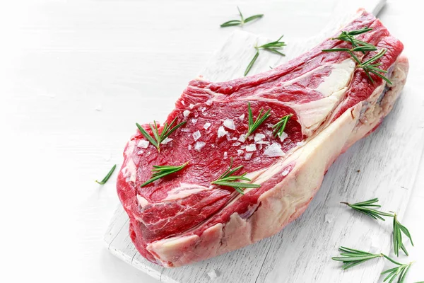 Fresh Raw Beef bone rib roughly choppid on white board with herbs — Stock Photo, Image