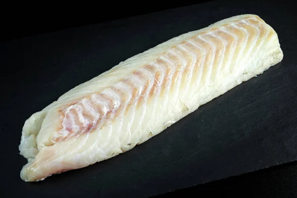 Fresh Raw Cod loin fillet on stone board — Stock Photo, Image