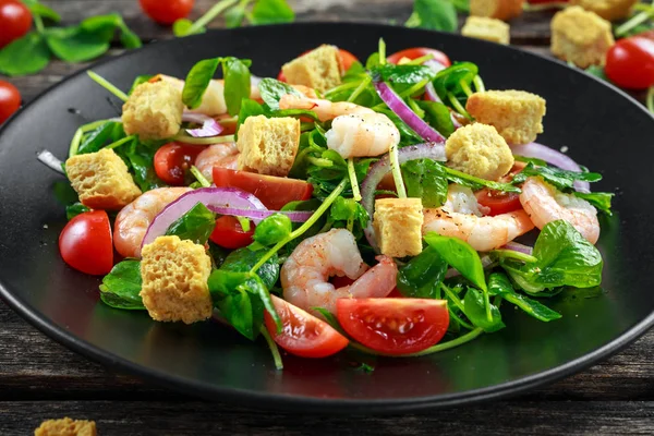 Siyah plaka üzerinde domates, kırmızı soğan ile taze sağlıklı karides salatası. kavram sağlıklı gıda