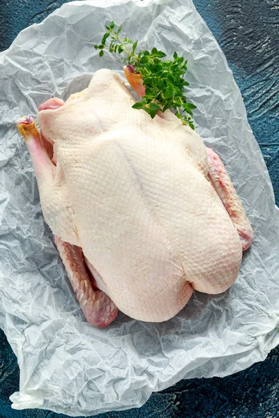 Free range duck ready to cook with pepper and thyme on baking paper — Stock Photo, Image