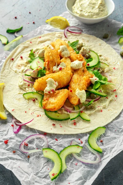 Taze balık Tortilla salatalık, kırmızı soğan, Kapari, limon, salata yaprakları ve çiğ sos ile. Sağlıklı gıda