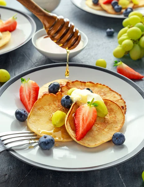 Homemade Pancakes with Blueberry, Strawberry, green Grape and honey syrup. served on plate — Stock Photo, Image