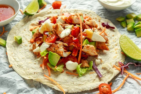 Chicken Tortilla wraps with fresh vegetable mix, avocado, lime, greek yogurt and sweet chilli sauce