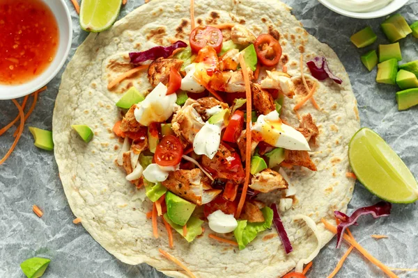 Chicken Tortilla wraps with fresh vegetable mix, avocado, lime, greek yogurt and sweet chilli sauce
