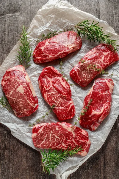 로즈마리와 백 리 향 종이 요리에 원시 유기 대리석된 쇠고기 스테이크 — 스톡 사진