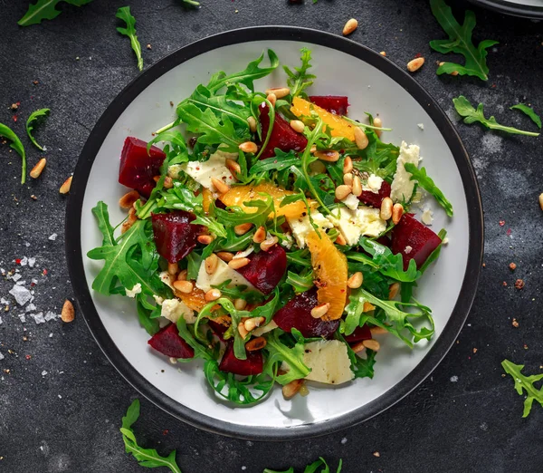 Свежая свекла, апельсиновый салат с дикой ракетой, сыром и сосновыми орехами. здоровое питание летом — стоковое фото