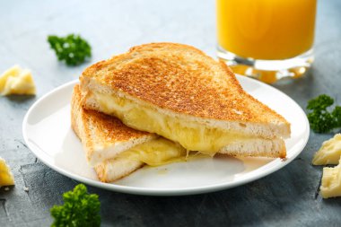 Grilled Cheese cheddar Sandwich on white plate clipart