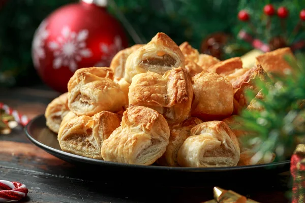 Christmas Sausage Rolls with decoration, gifts, green tree branch on wooden rustic table — Stock Photo, Image