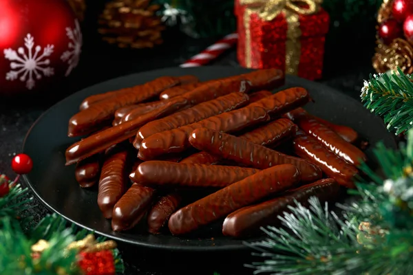 Lebkuchen sticks dipped in dark chocolate with cranberry filling, Christmas party treat sweet snacks — Stock Photo, Image