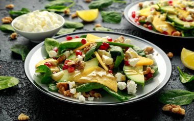 Hurma, ıspanaklı avokado salatası, beyaz peynir, ceviz ve nar tohumu. Sağlıklı yemek..