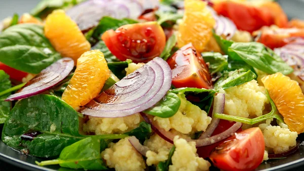 Vegetáriánus köles saláta vörös hagymával, cseresznyés paradicsommal, spenóttal, mandarinnal és clementine öntettel. egészséges élelmiszerek — Stock Fotó