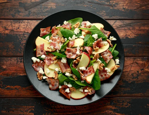 Бекон, яблочный салат со шпинатом, грецкими орехами и сыром фета. на деревянном столе. здоровое питание . — стоковое фото