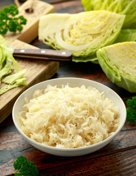 Fresh pickled cabbage in white bowl on wooden table. healthy food — Stockfoto