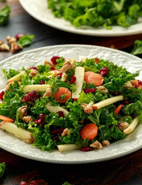 Kale salad with dried cranberry, carrots, walnuts and apple. healthy vegan food. — Stock Image Kale salad with dried cranberry, carrots, walnuts and apple. healthy vegan food. Royalty Free Stock Images