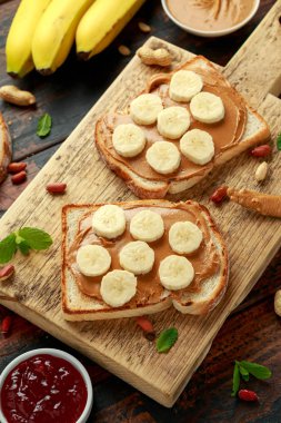 Peanut Butter and banana Sandwich on wooden board. morning breakfast