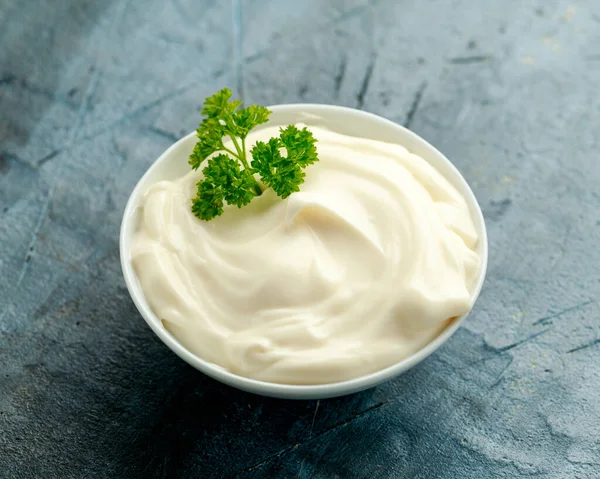 Mayonnaise sauce in a white bowl on old rustic table — Stock Photo, Image