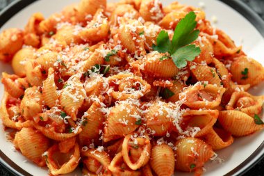 Domates soslu nohut ve parmesan peynirli Conchiglie rigate makarnası. Sağlıklı vejetaryen yemekleri.
