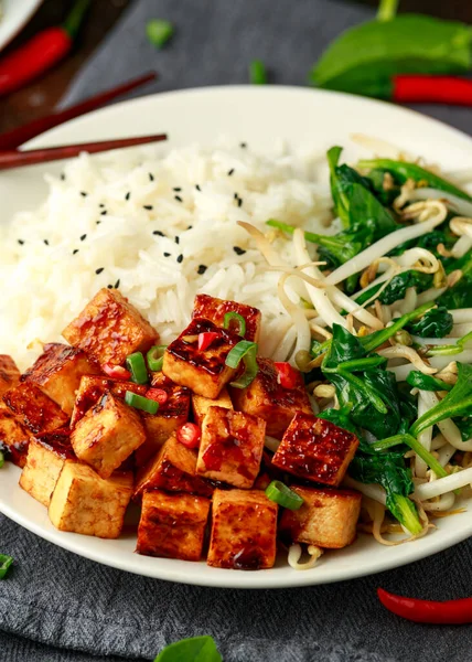 Gebratener asiatischer Tofu in süßer Chiliglasur, serviert mit Reis, gedämpftem Spinat und Sitzsprossen. Pflanzliche gesunde Lebensmittel — Stockfoto