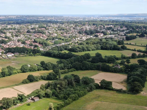 An aerial view of countryside and the edge of a town , Corfe Mullen, looking towards Poole Harbour in the distance — Stock Photo, Image
