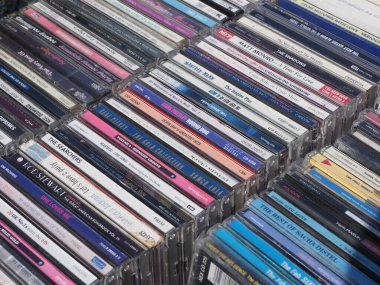 close up of a stack of various compact discs, cds