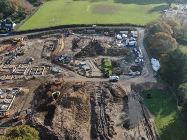 Yeşil tarlaların kenarındaki konut inşaatının havadan görünüşü