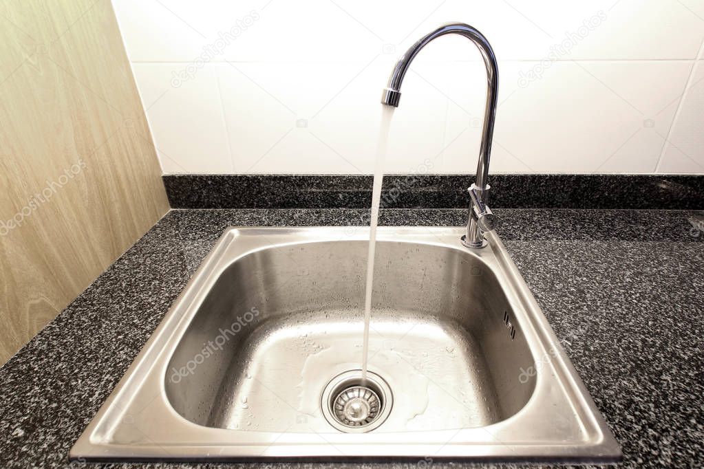 kitchen sink with running water from faucet