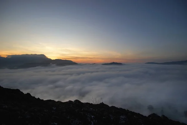 Sunrise over the hills with sea fog — Stock Photo, Image