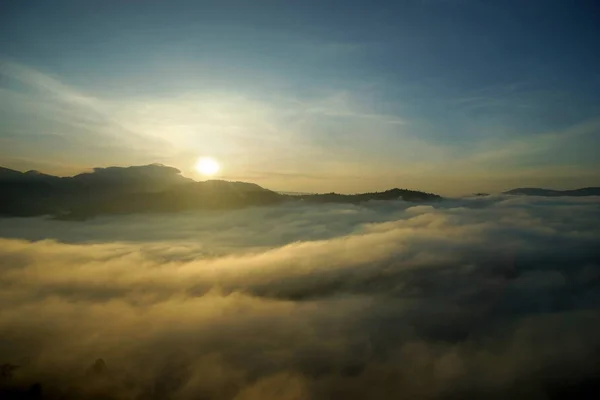 Sea fog over the hills with sunrise background — Stock Photo, Image