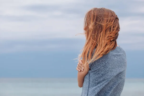 Woman alone and depressed at seaside Stock Picture