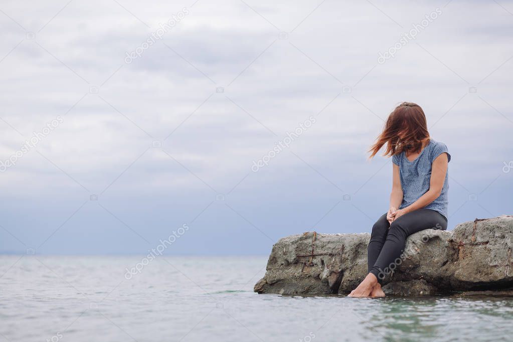 Woman alone and depressed on the bridge